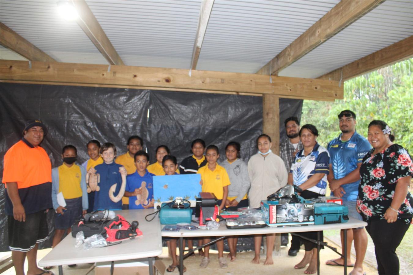 Niue school students and project representatives standing with supplied tools