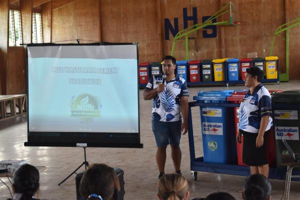 Waste Management Project representatives presenting recycling bins at Niue High School